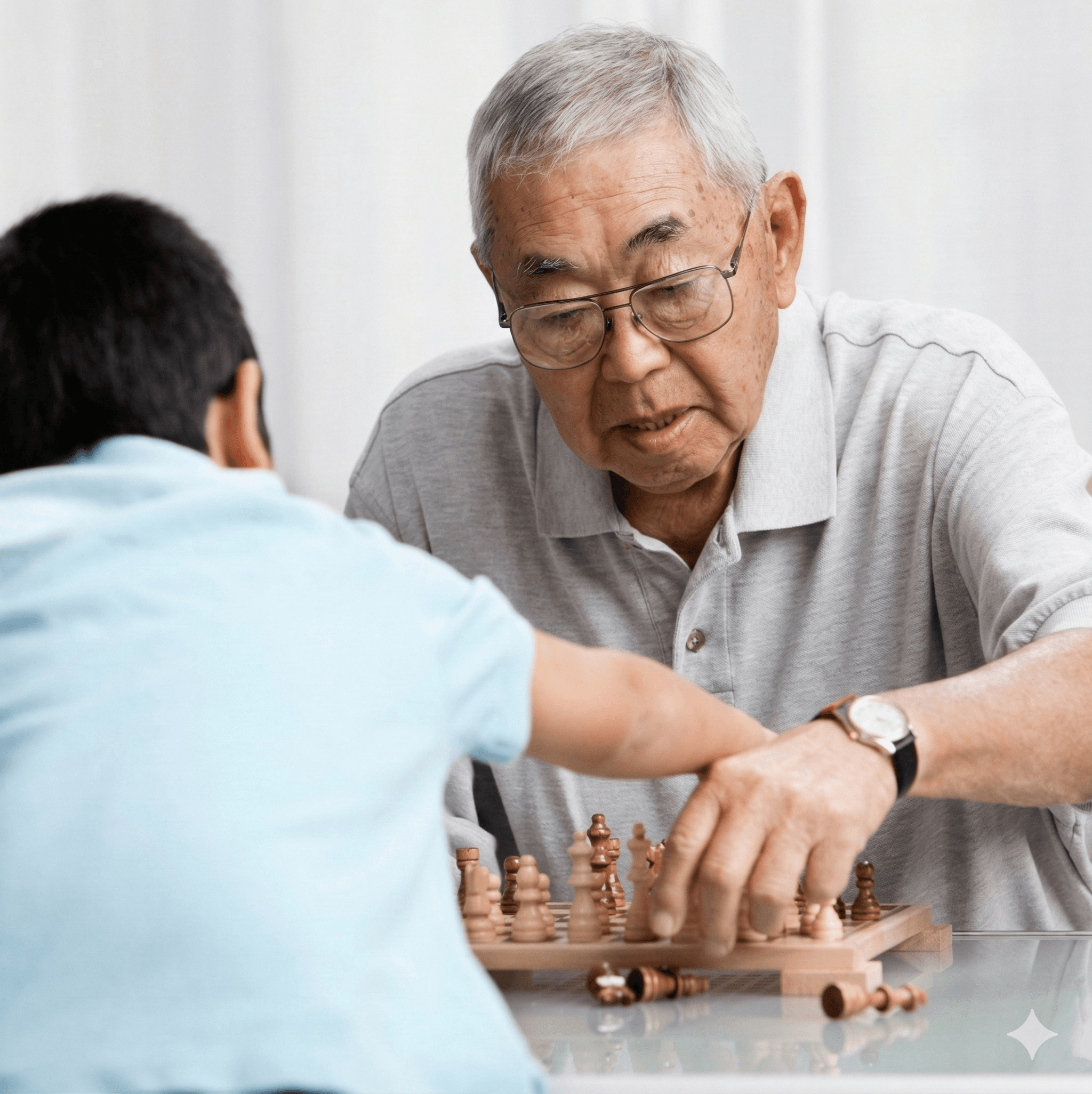 elderly man playing chess with grandson