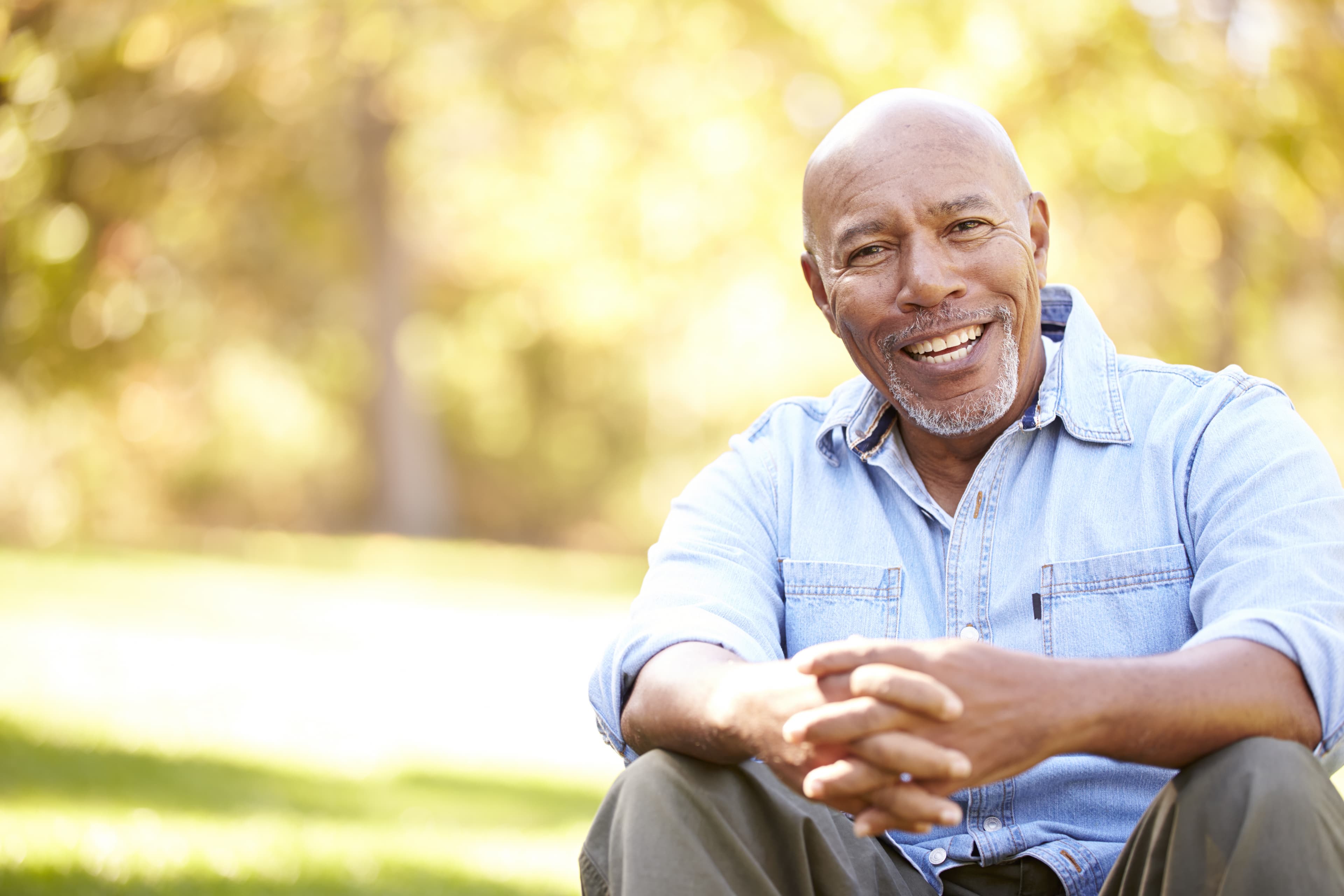 man-elderly-sitting-smiling-outdoors
