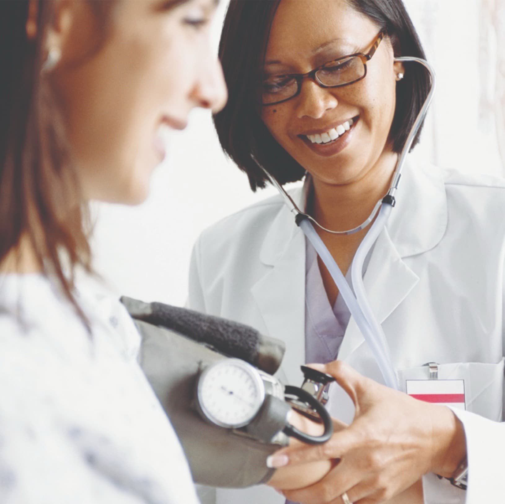 female doctor and female patient stethoscope vertical